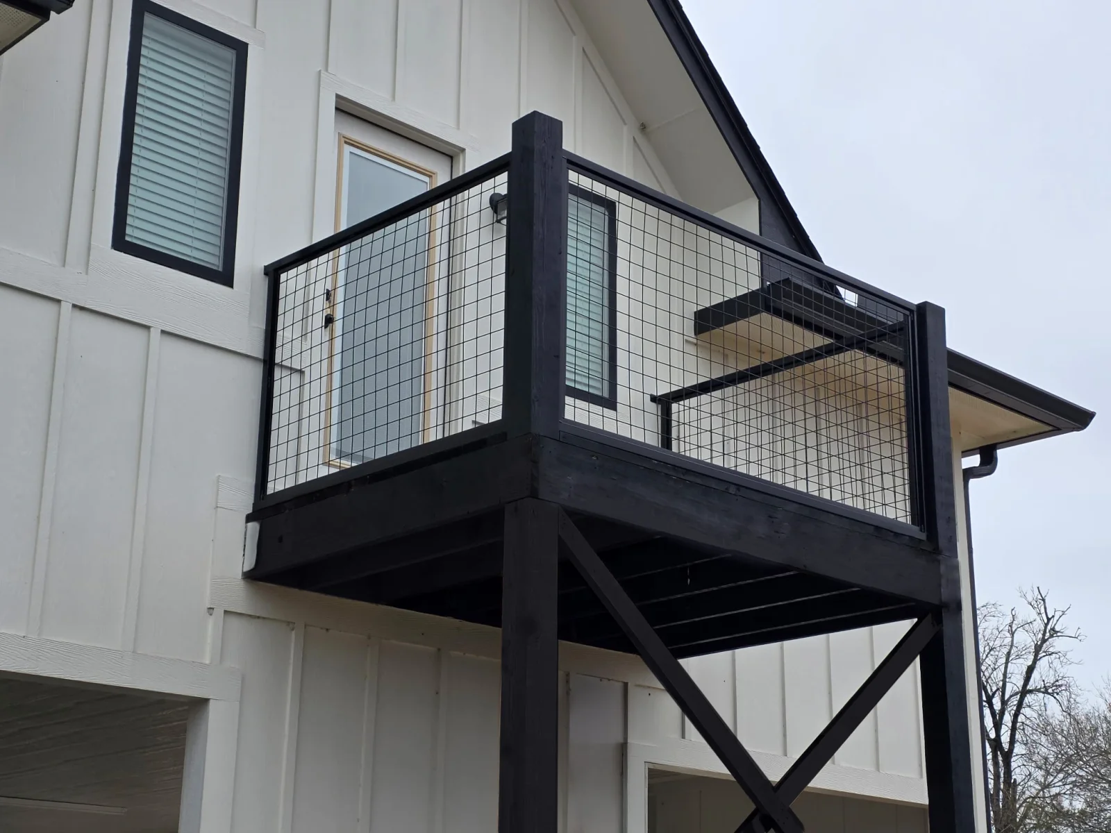 Elevated deck with a wire panel deck railing