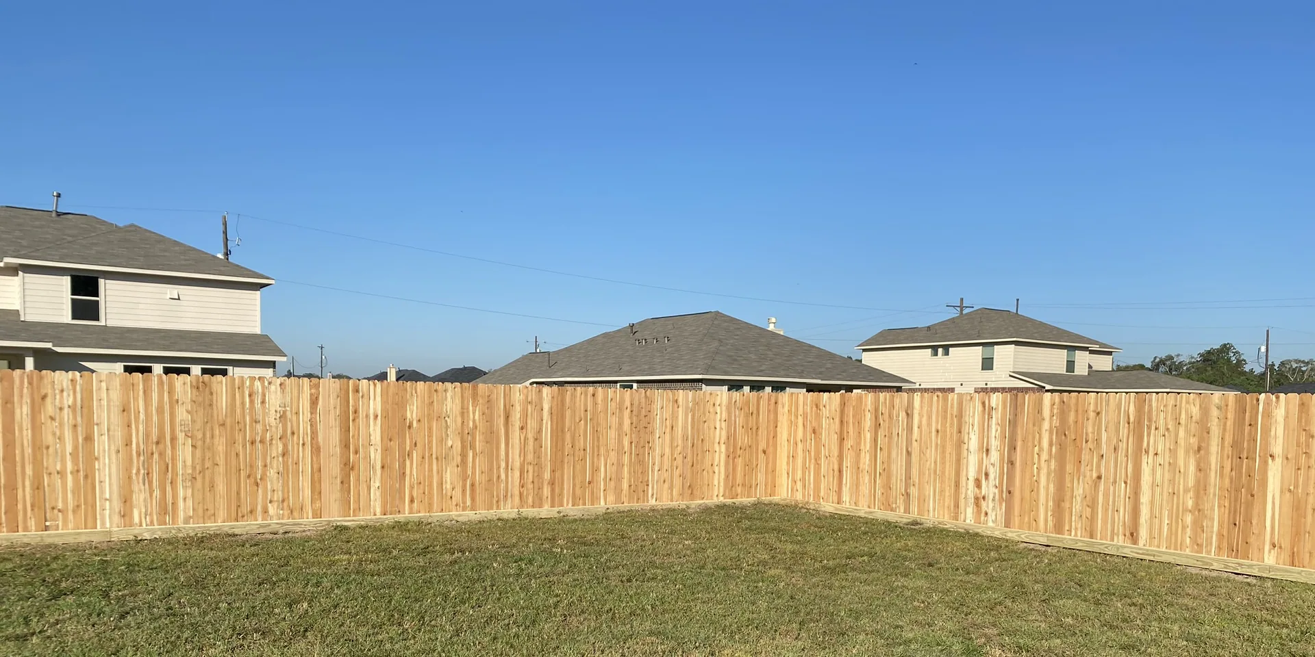 New privacy fence along the back property line of a new-build lot