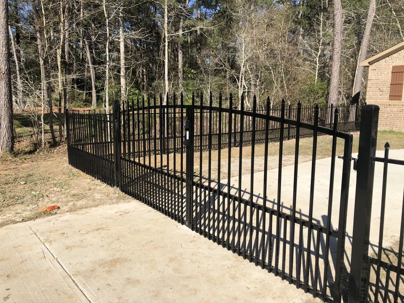 Black ornamental iron double driveway gate
