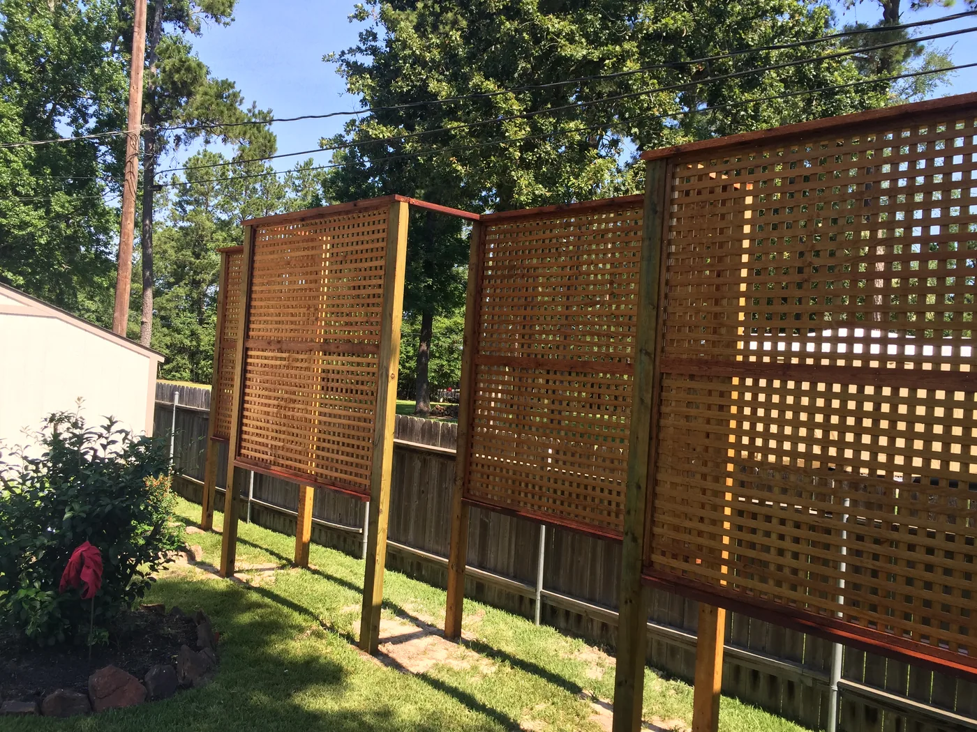 Cedar lattice privacy screens on posts