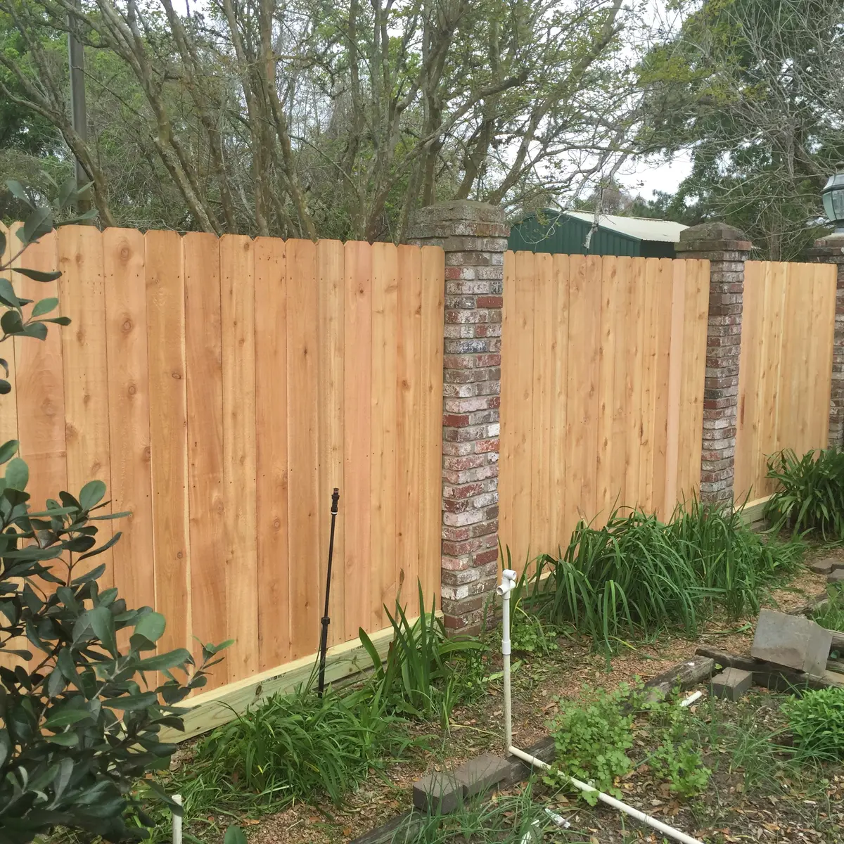 Privacy fence panels set between brick columns
