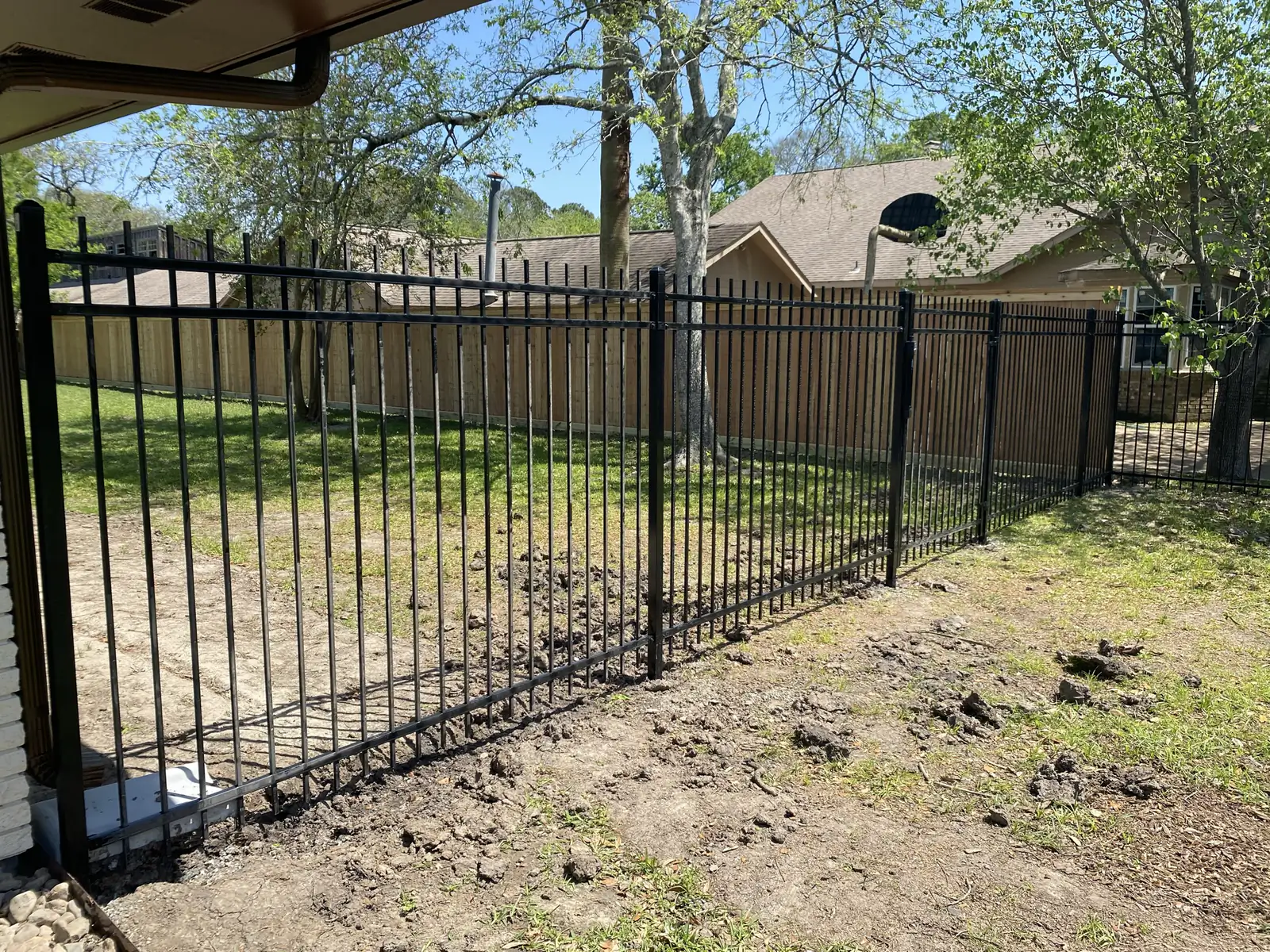 Ornamental iron fence panels along a back property line